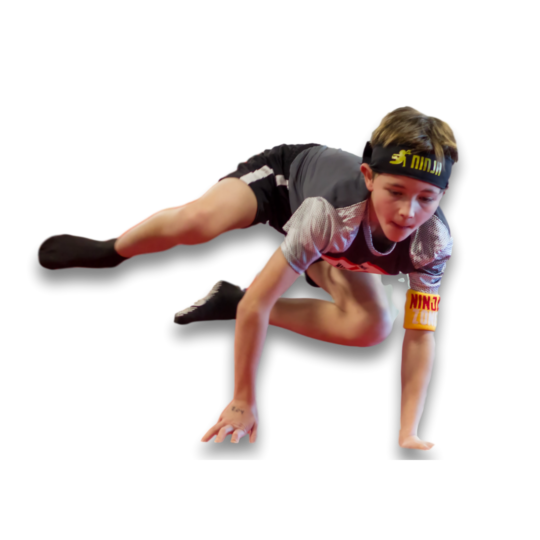 A young girl is doing a handstand on a balance beam in a gym.