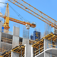 A large building under construction with a crane in the foreground