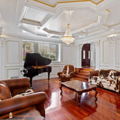 A living room with a piano couch and chairs