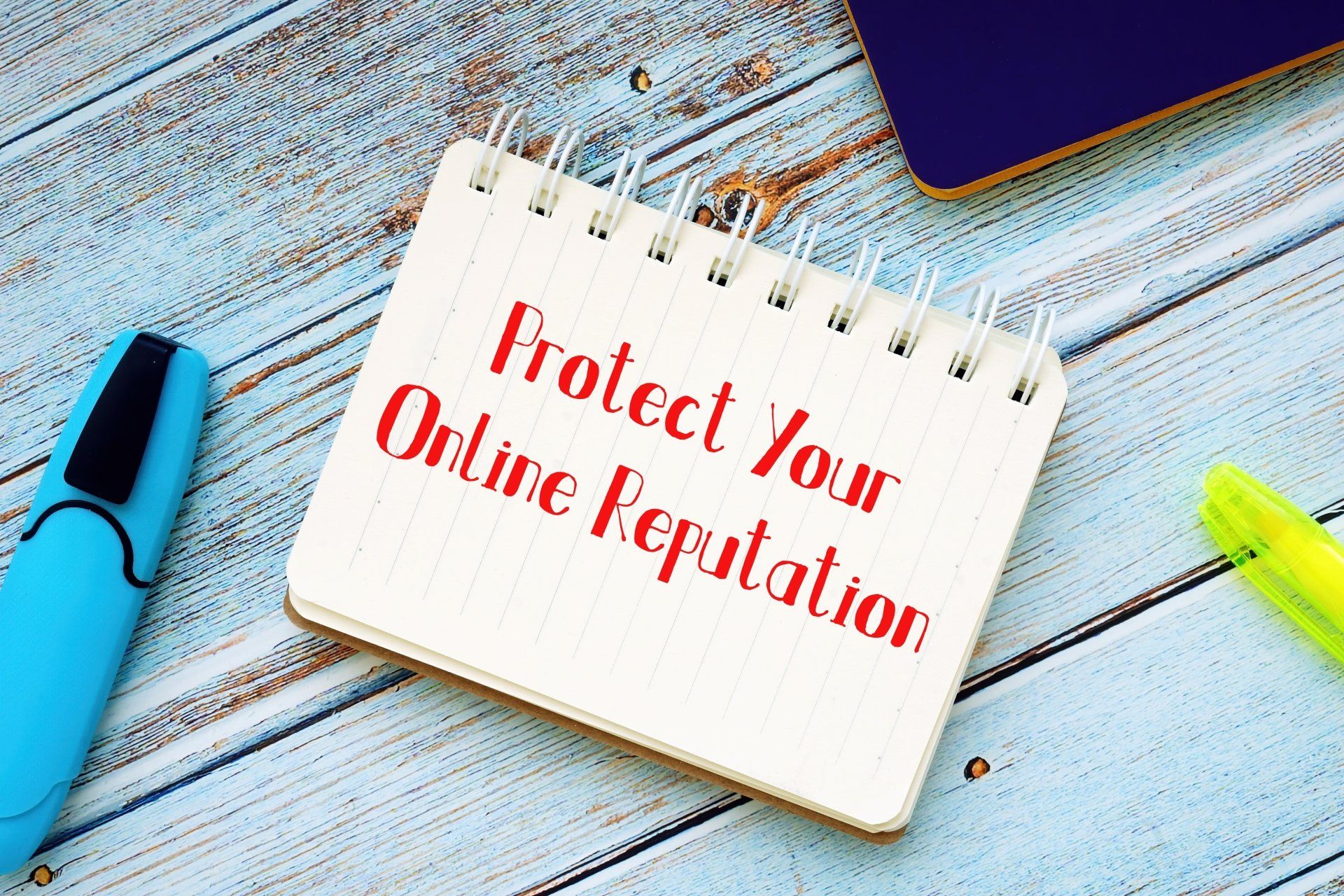 Notepad with the words, 'Protect your Online Reputation' written on the front page.