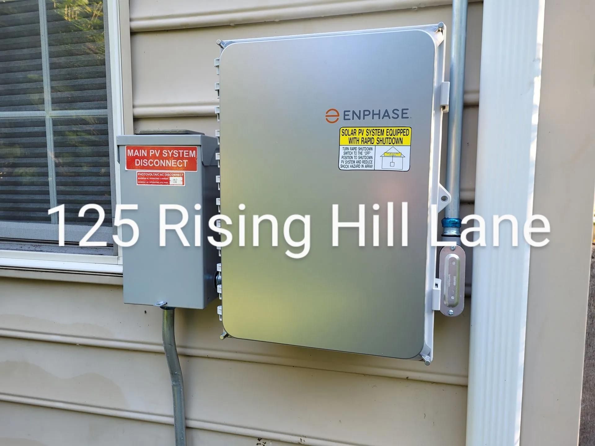 Solar panel equipment box and electrical panel on a house exterior at 125 Rising Hill Lane.