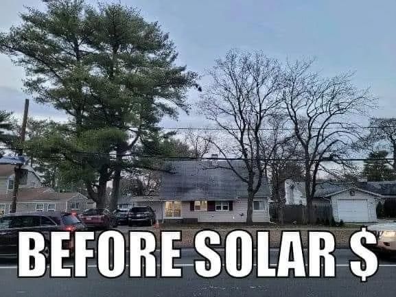 House before solar panel installation. Road in front with parked cars and trees on either side. 