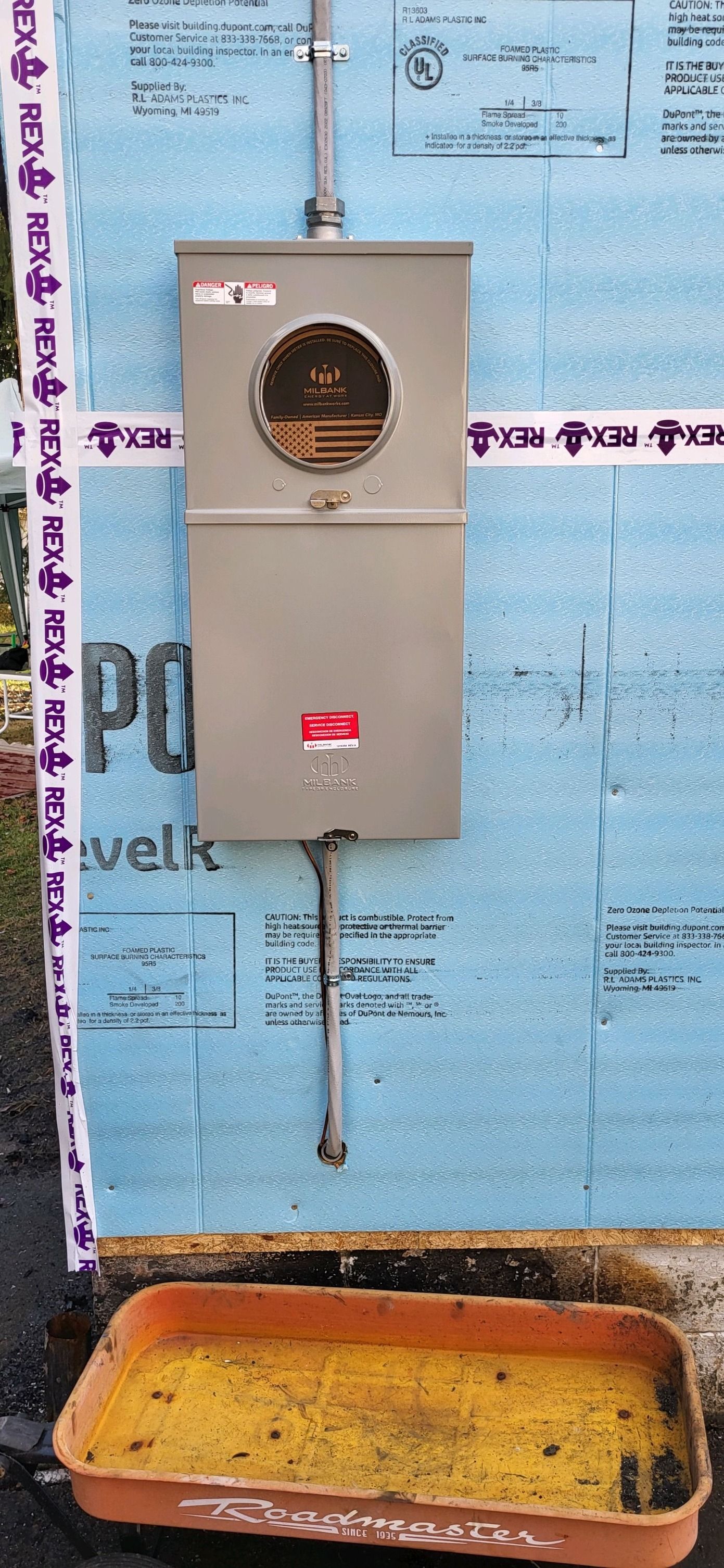 A box is sitting on a wall next to a tray of food.