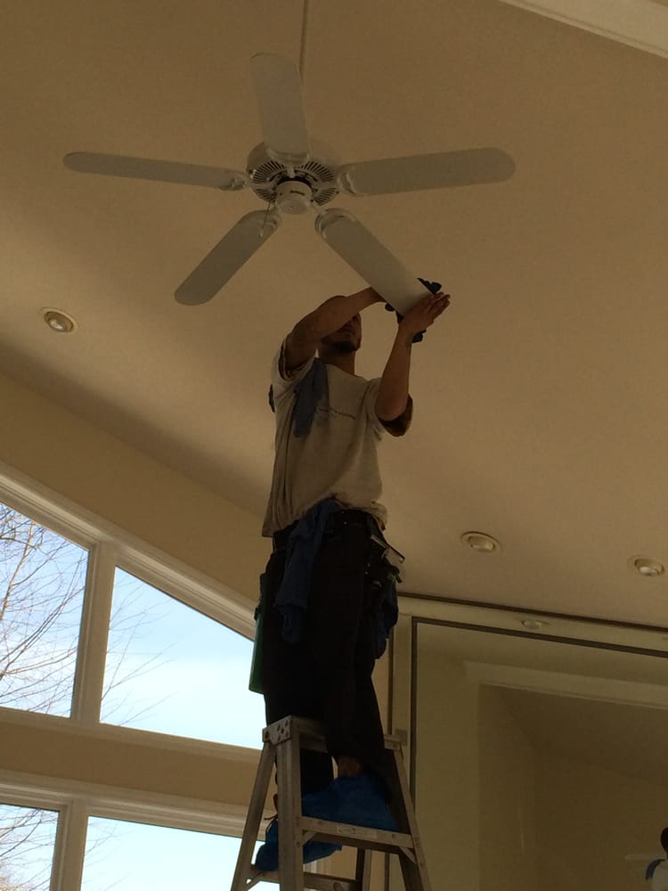 Fan Cleaning — A Man Cleaning The Ceiling Fan in Bloomfield, MI
