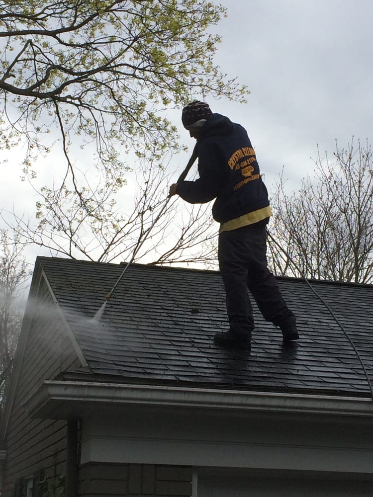 Roof Cleaning — Man Cleaning The Roof in Bloomfield, MI
