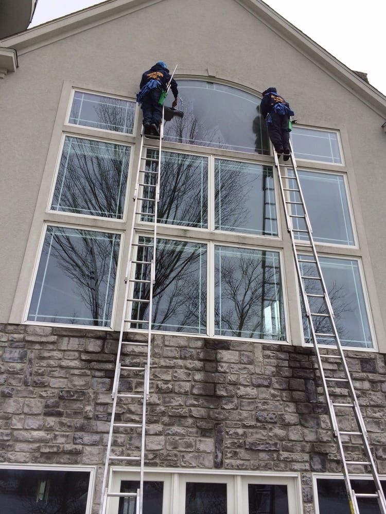 Window Cleaning Reviews — Two Men Cleaning The Window Outside in Bloomfield, MI