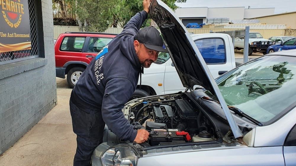 A Man Is Working Under the Hood of A Car — Andy's A1 Auto Care in Barrack Heights, NSW