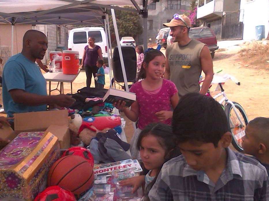 A group of children are gathered around a table with a basketball that says monterey on it