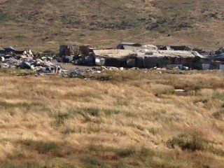 A large field with a building in the middle of it