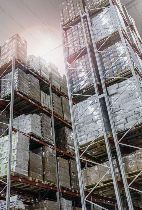 a large refrigeration warehouse filled with lots of boxes and shelves .