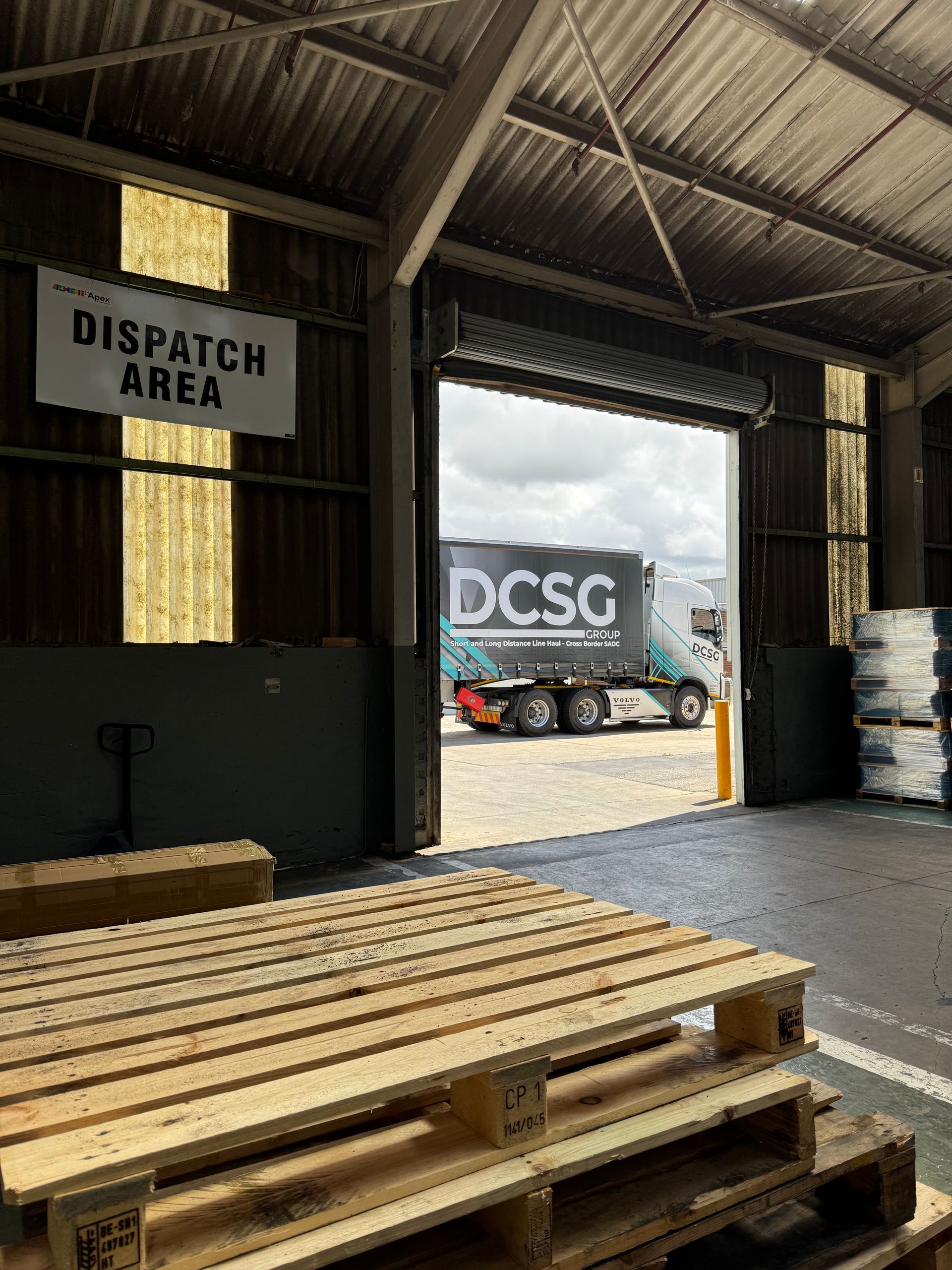 A large empty warehouse with a lot of machinery in it.