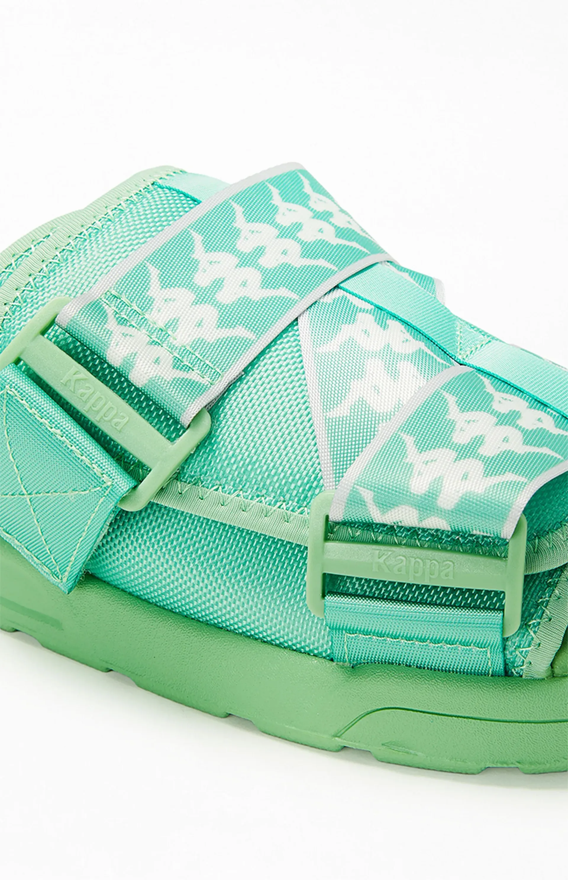 Green sandals with white snowflake pattern.