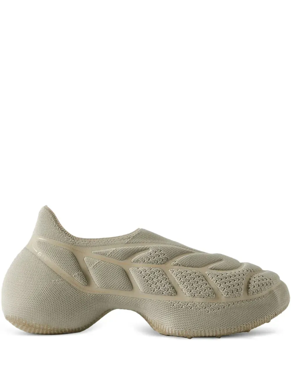 Beige sculpted shoe with a textured, porous design.