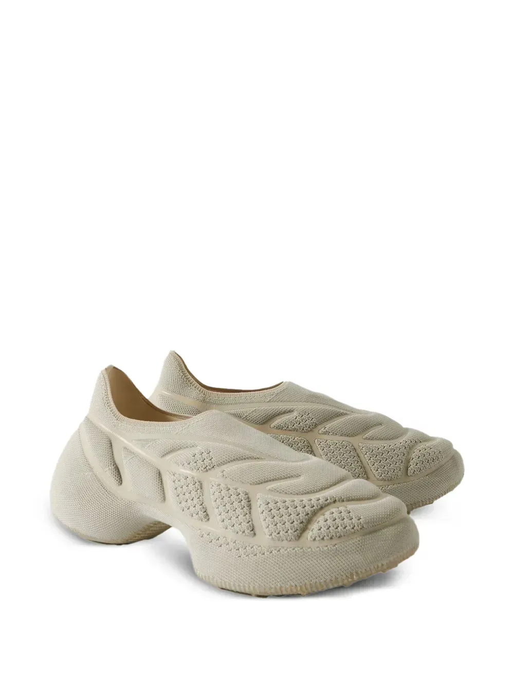 Beige sculpted shoe with a textured, porous design.