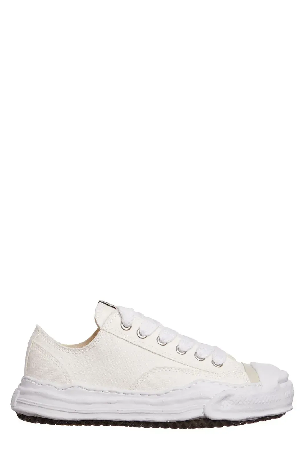 White low-top sneakers with a distressed, textured appearance and a black sole.