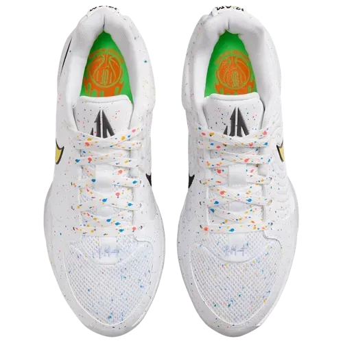 White Nike basketball shoes with yellow swoosh, speckled details.