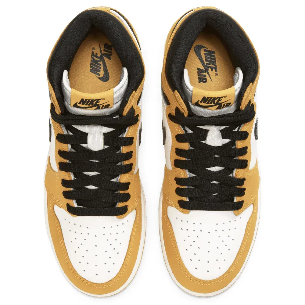 Pair of mustard yellow, white, and black Air Jordan 1 high-top sneakers.