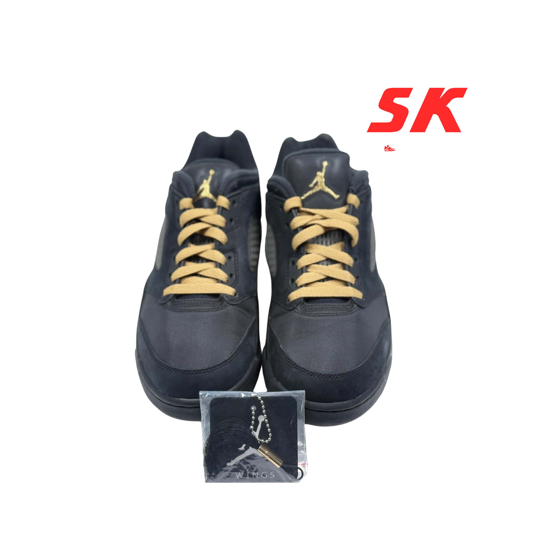 Black and gold Air Jordan 5 Low sneakers with a matching bag on a white background.