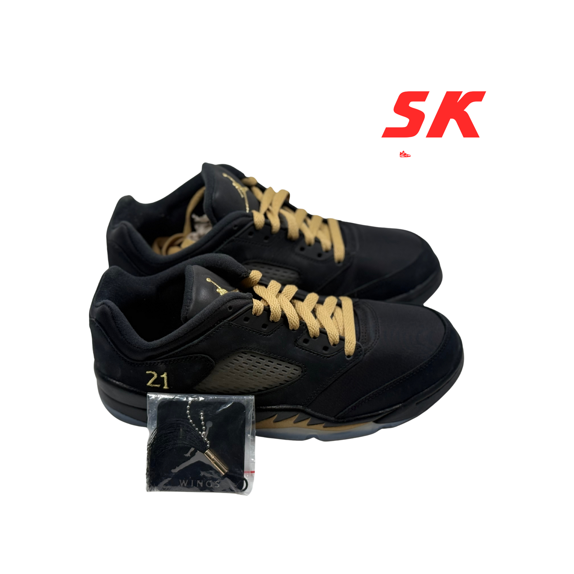 Black and gold Air Jordan 5 Low sneakers with gold laces and a 21 on the side, presented with an extra tag.