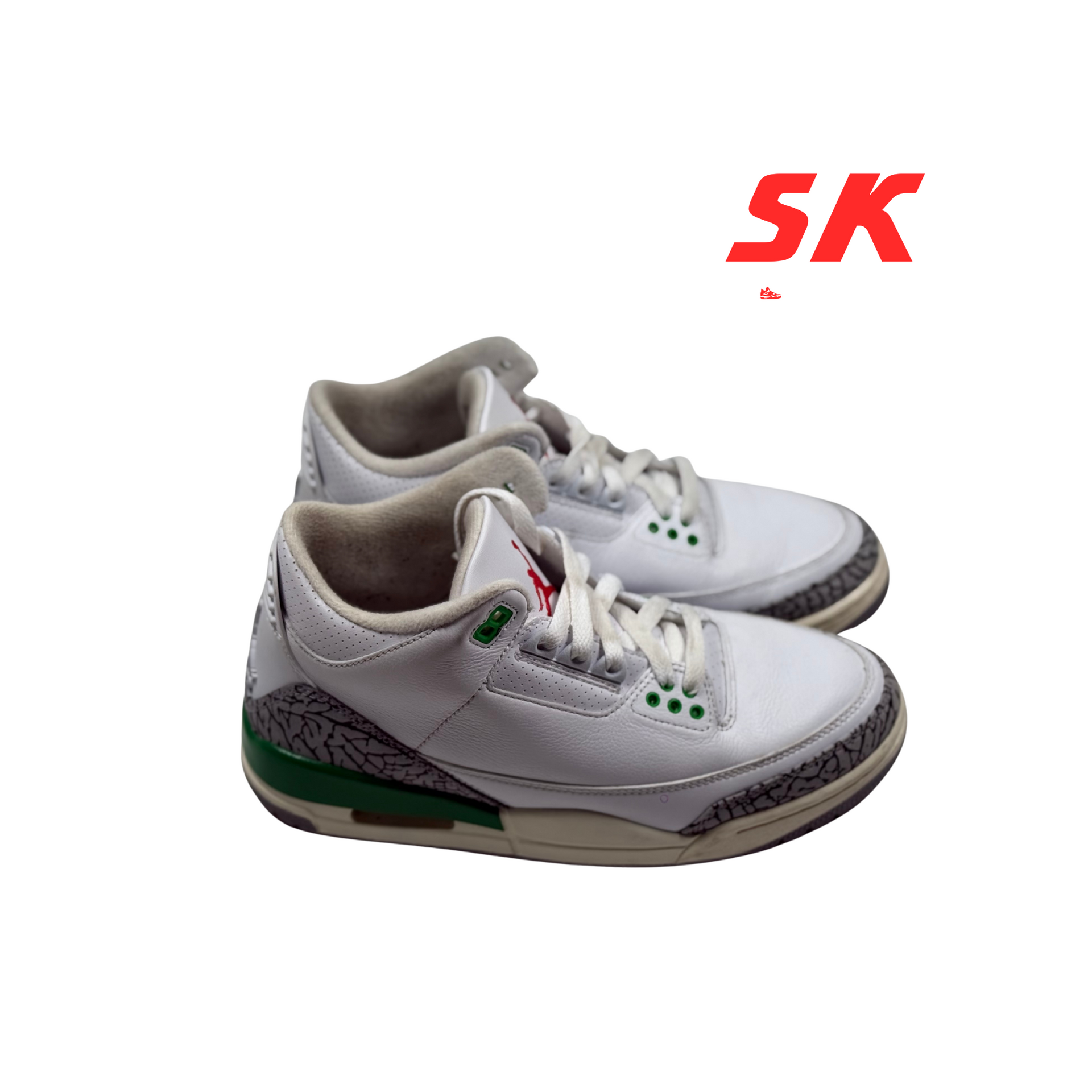 White and green toddler Air Jordan sneakers with elephant print accents.