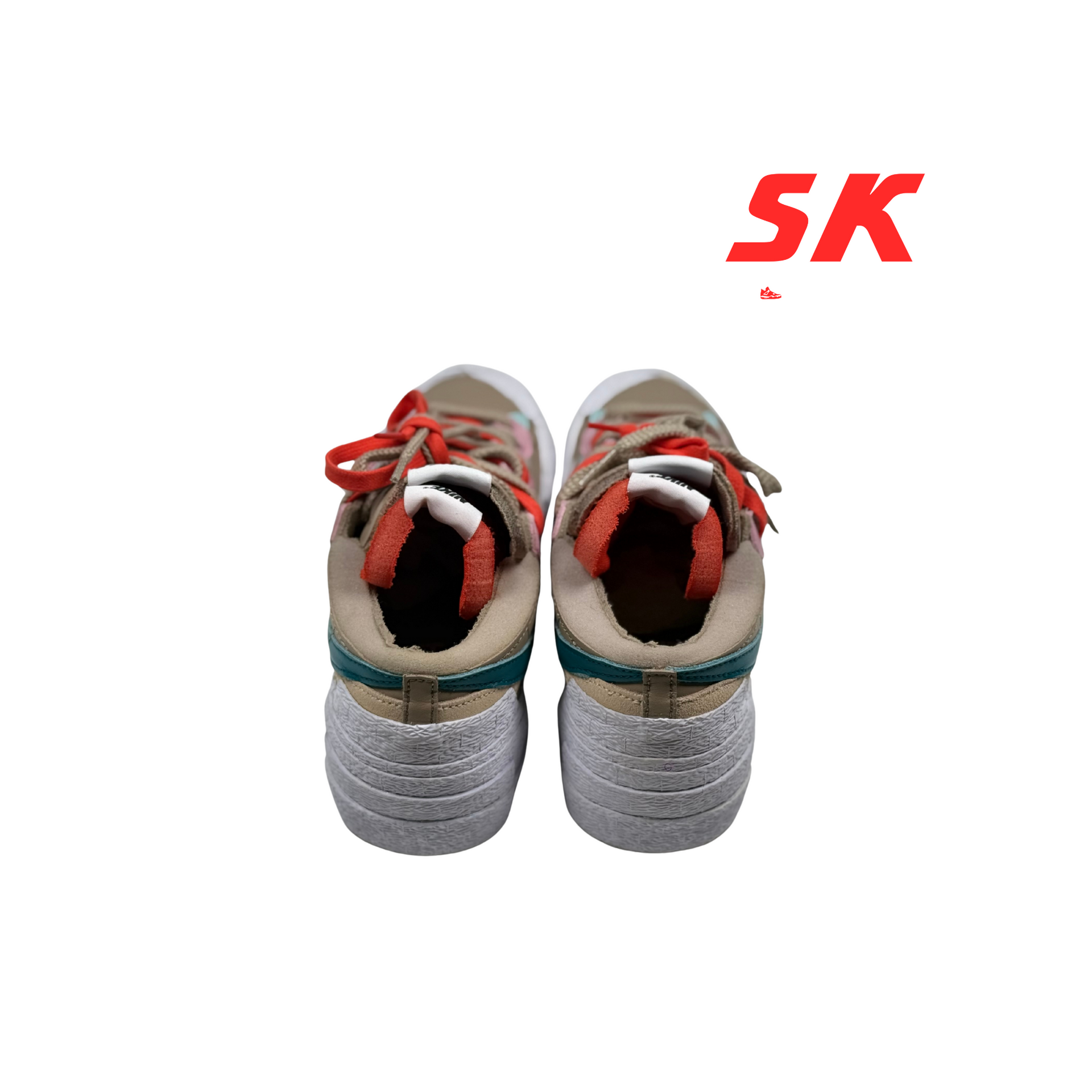 A pair of beige and teal Nike sneakers with red and pink accents, on a white background. 