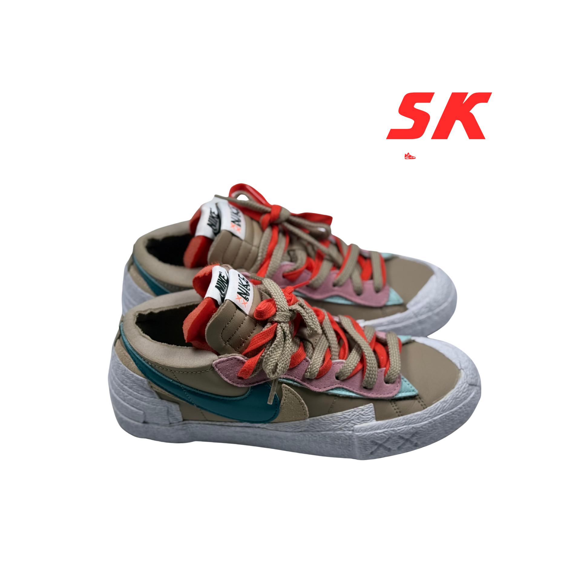 A pair of beige and teal Nike sneakers with red and pink accents, on a white background. 