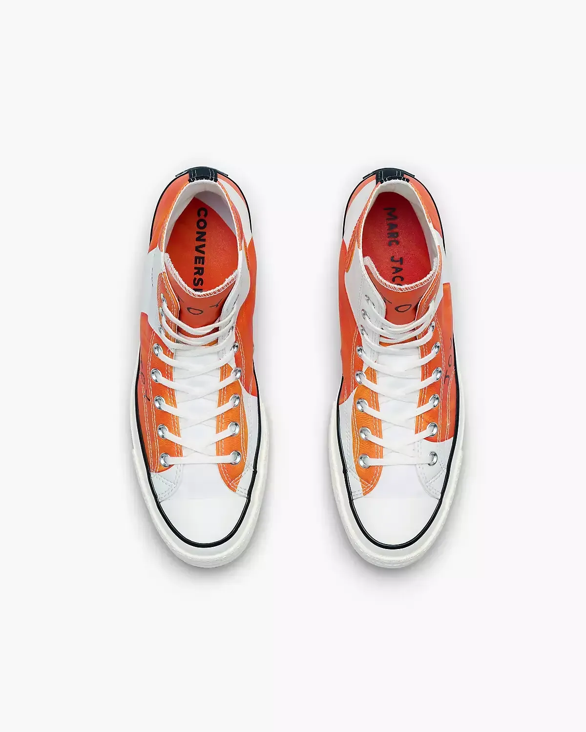 Pair of orange and white Converse high-top sneakers from a top-down view.