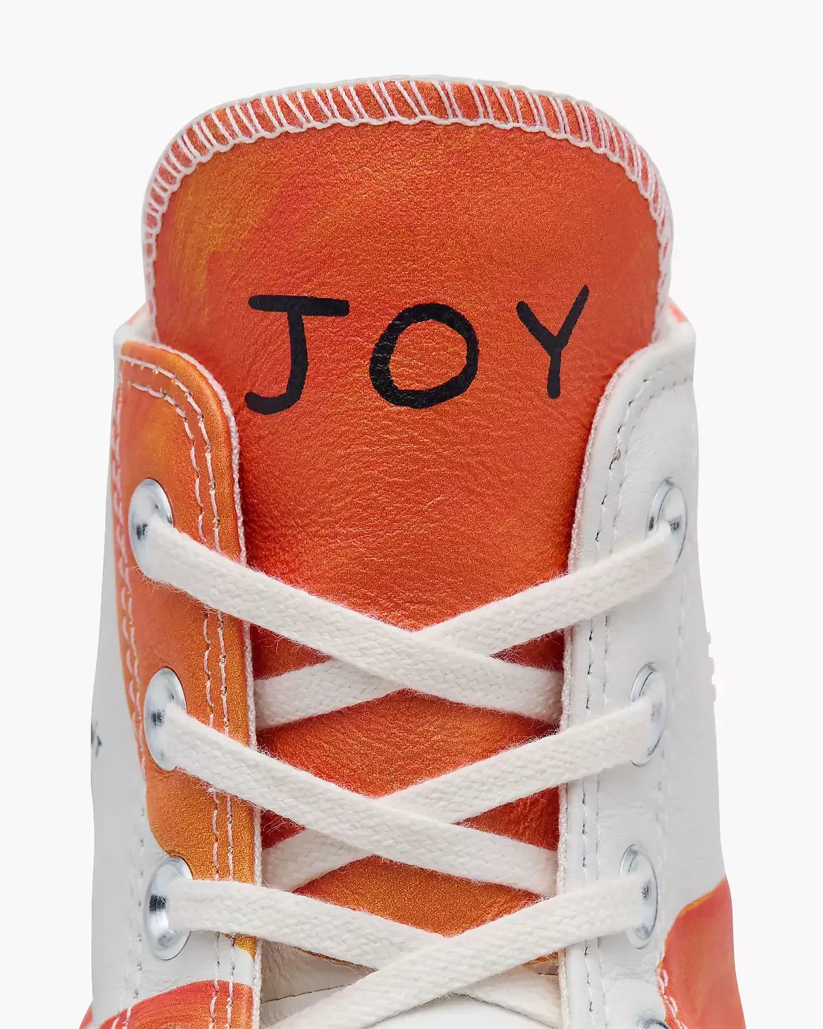 High-top Converse sneaker with orange glitter tongue; 