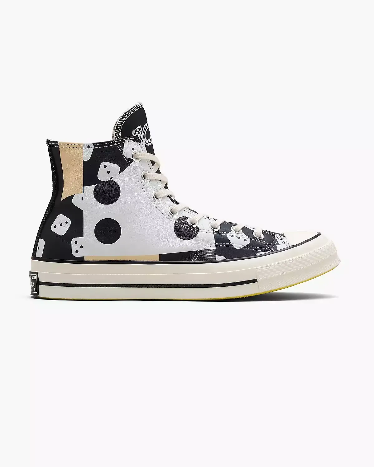 High-top Converse sneaker with a black and white pattern on a white base and cream sole.