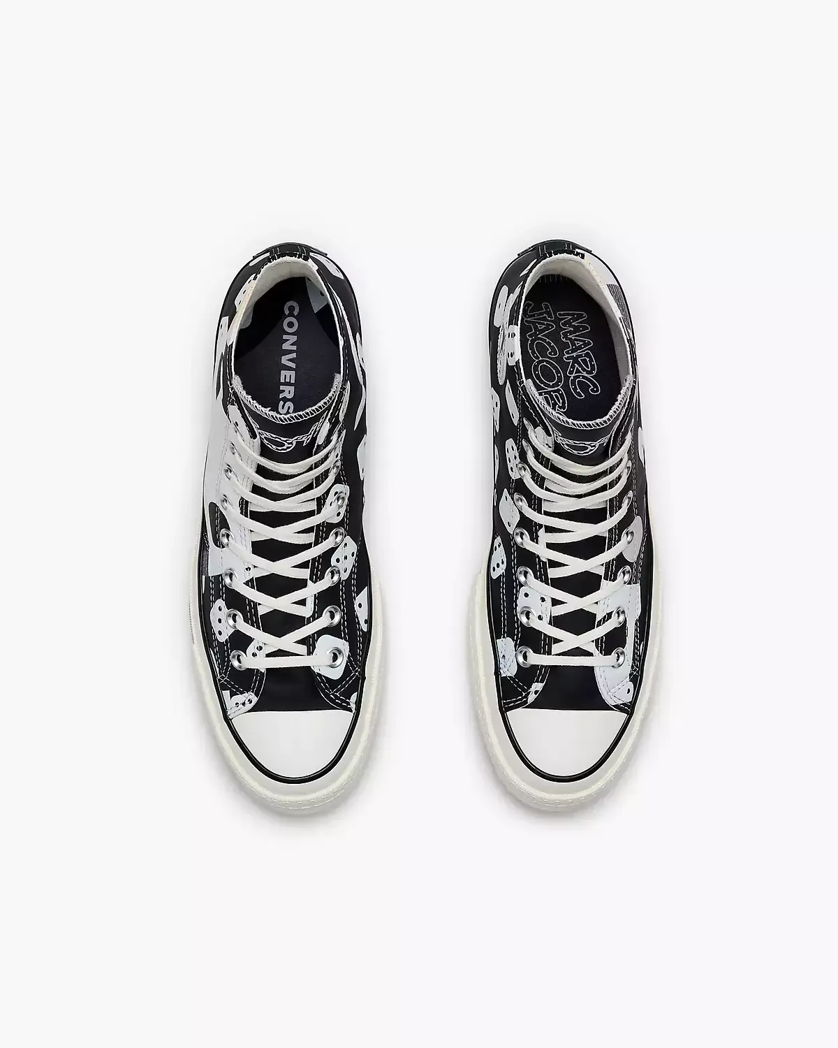Black and white high-top Converse sneakers with a polka dot and abstract pattern design.
