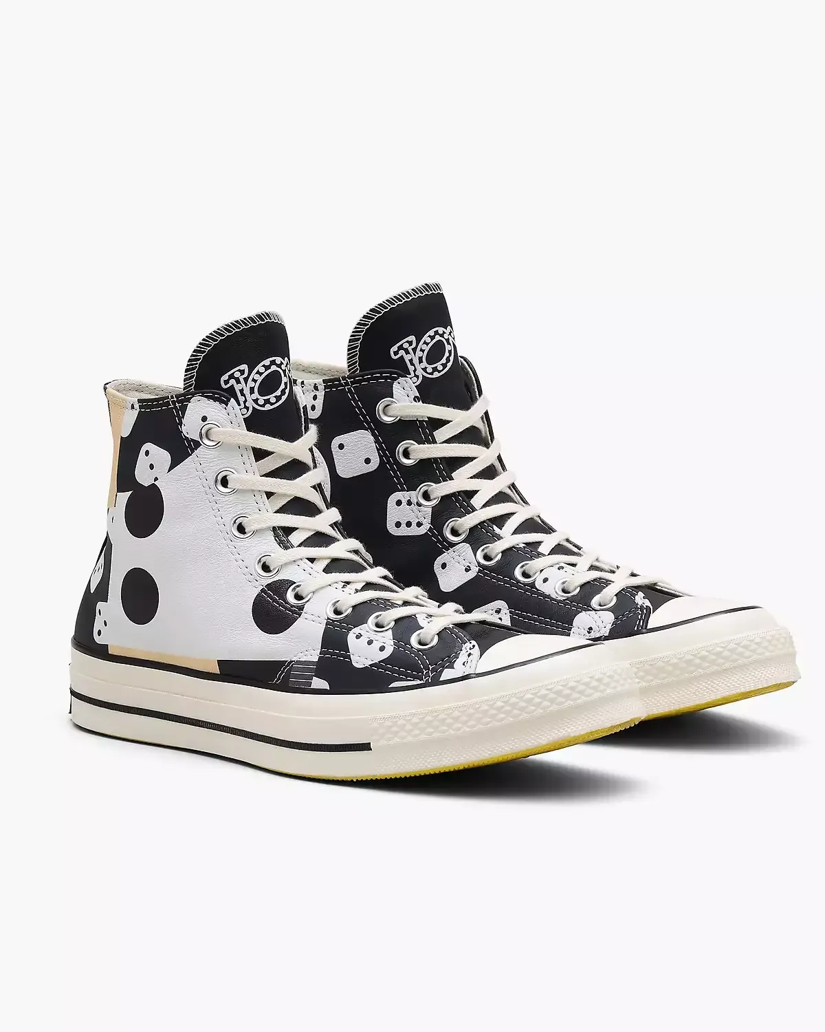Black and white high-top Converse sneakers with a polka dot and abstract pattern design.