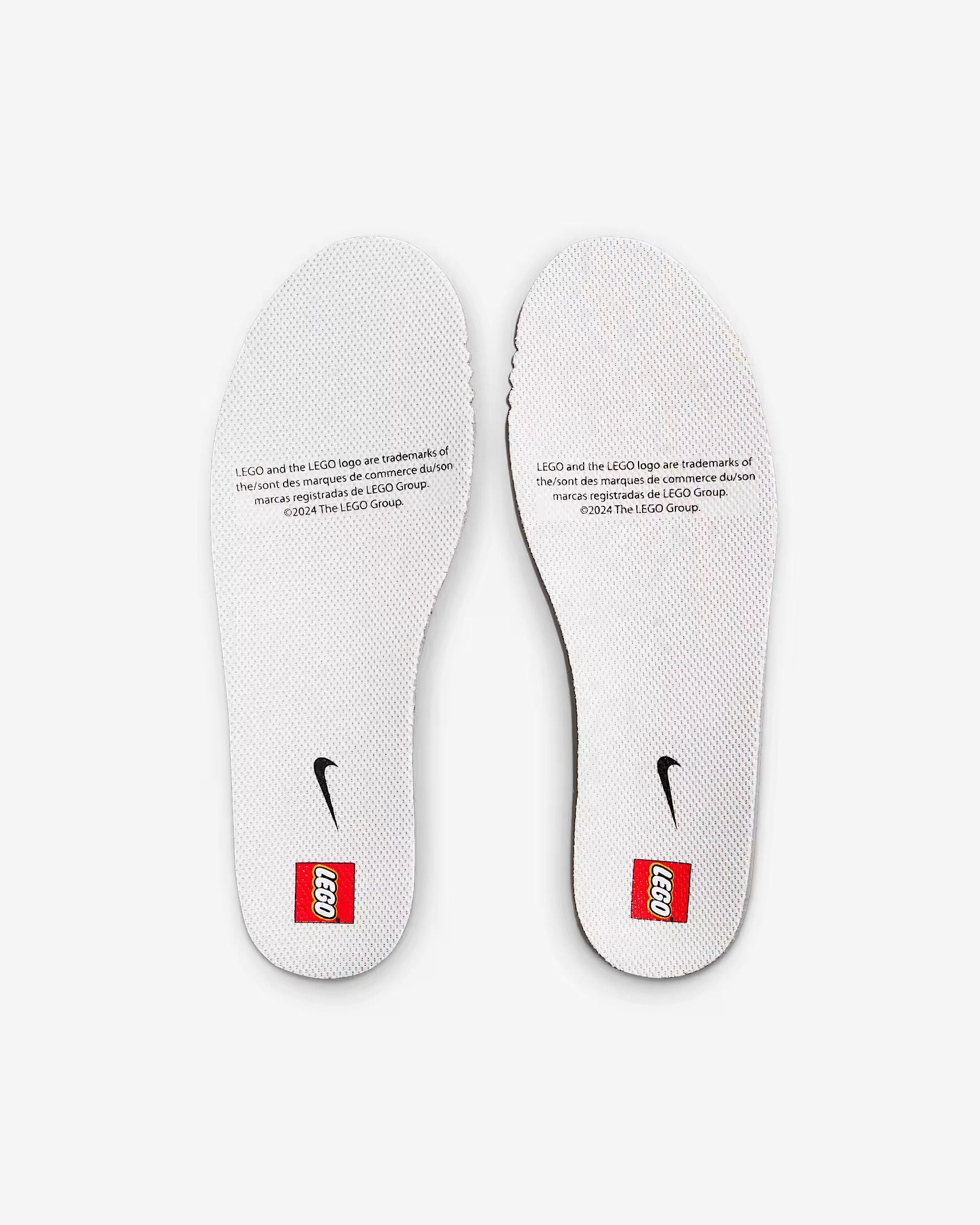 Two white Nike shoe insoles with text and logos, laid side by side.