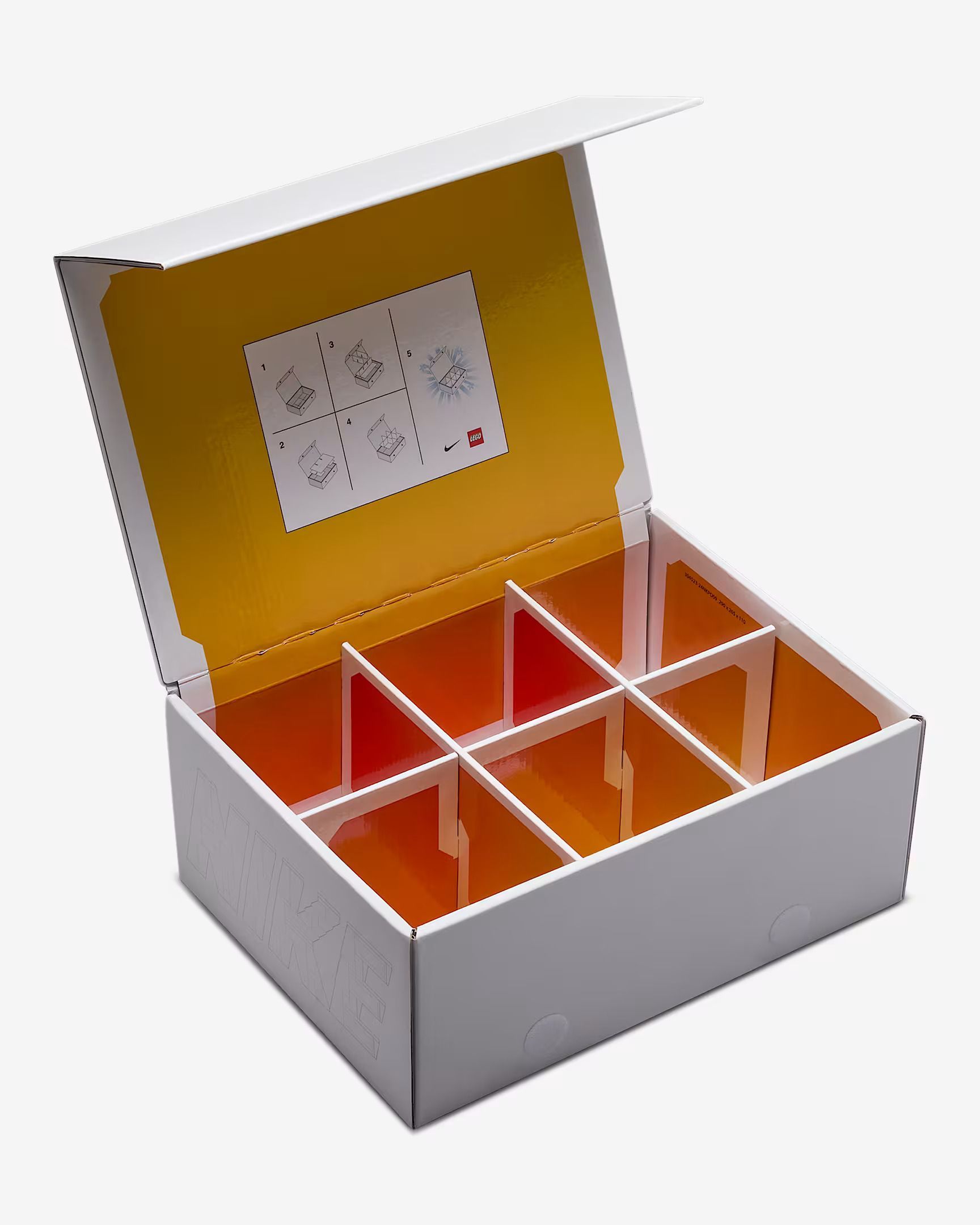 White box with yellow interior, divided into eight compartments, lid partially open.