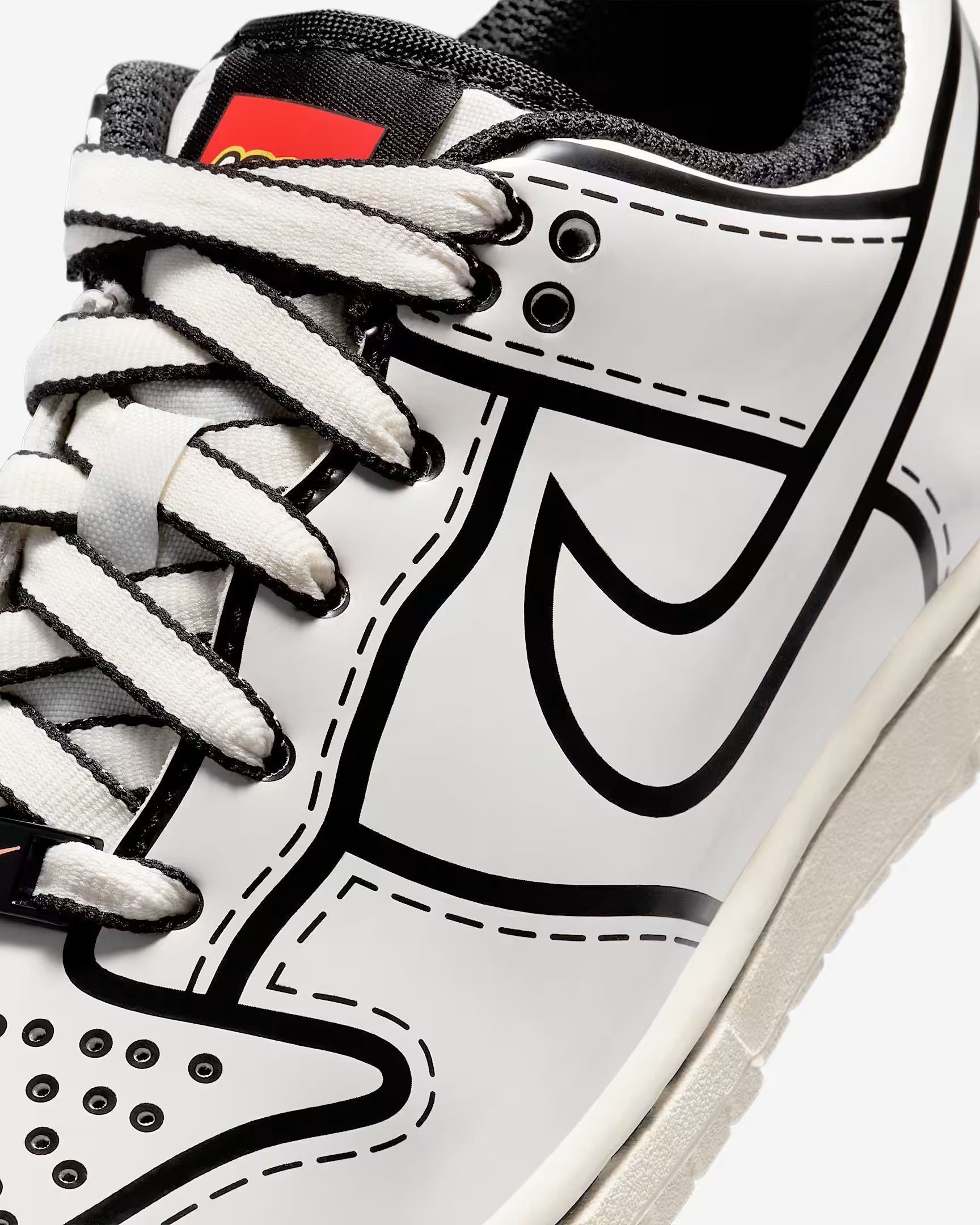 White Nike Dunk Low shoe with black outline detailing.
