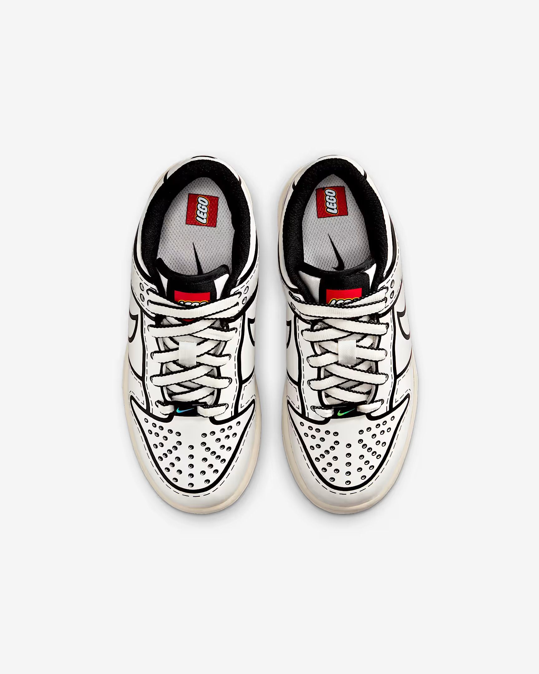White and black Nike sneakers with cartoon-like line art detailing.