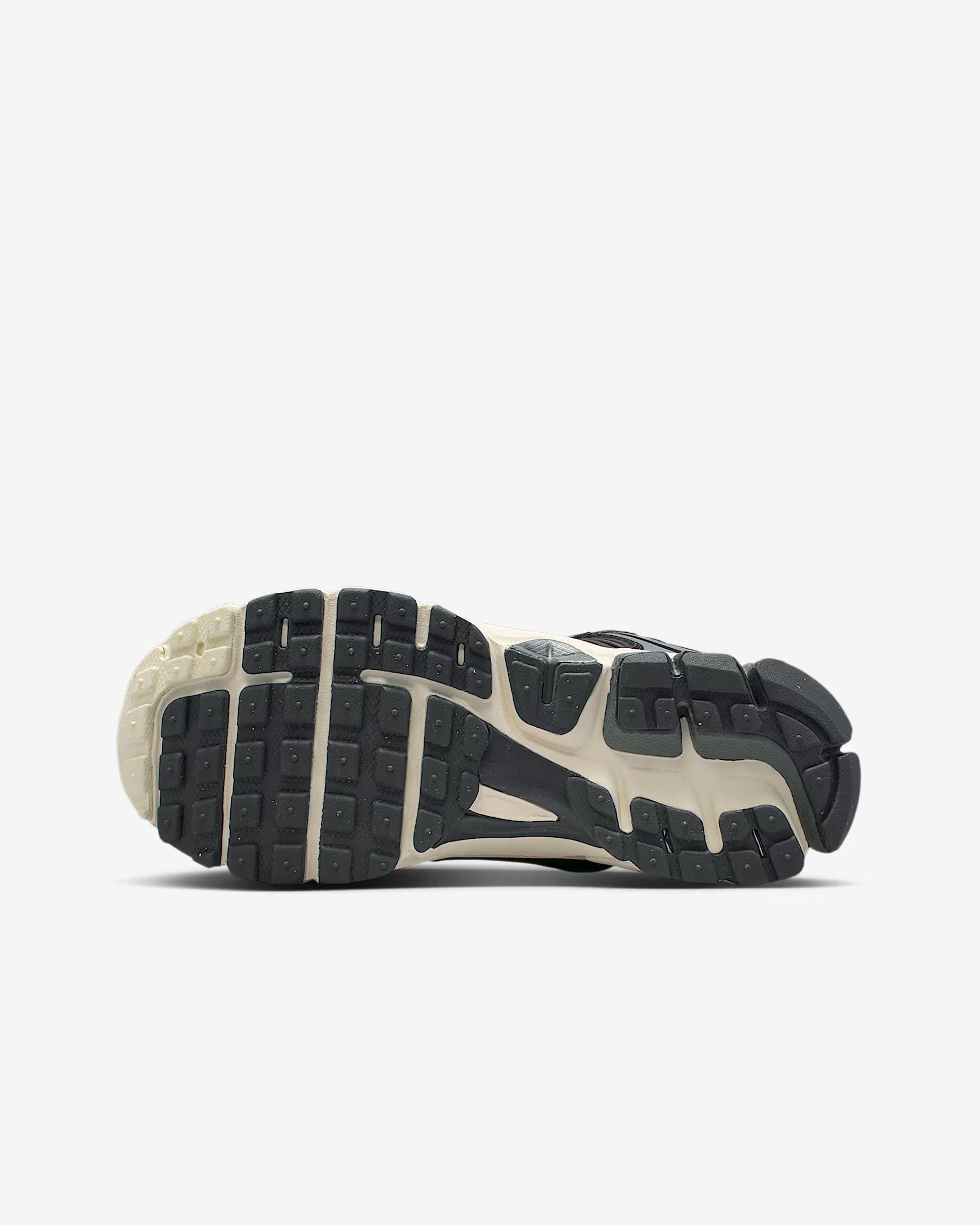 Bottom view of a black and beige running shoe sole with tread.