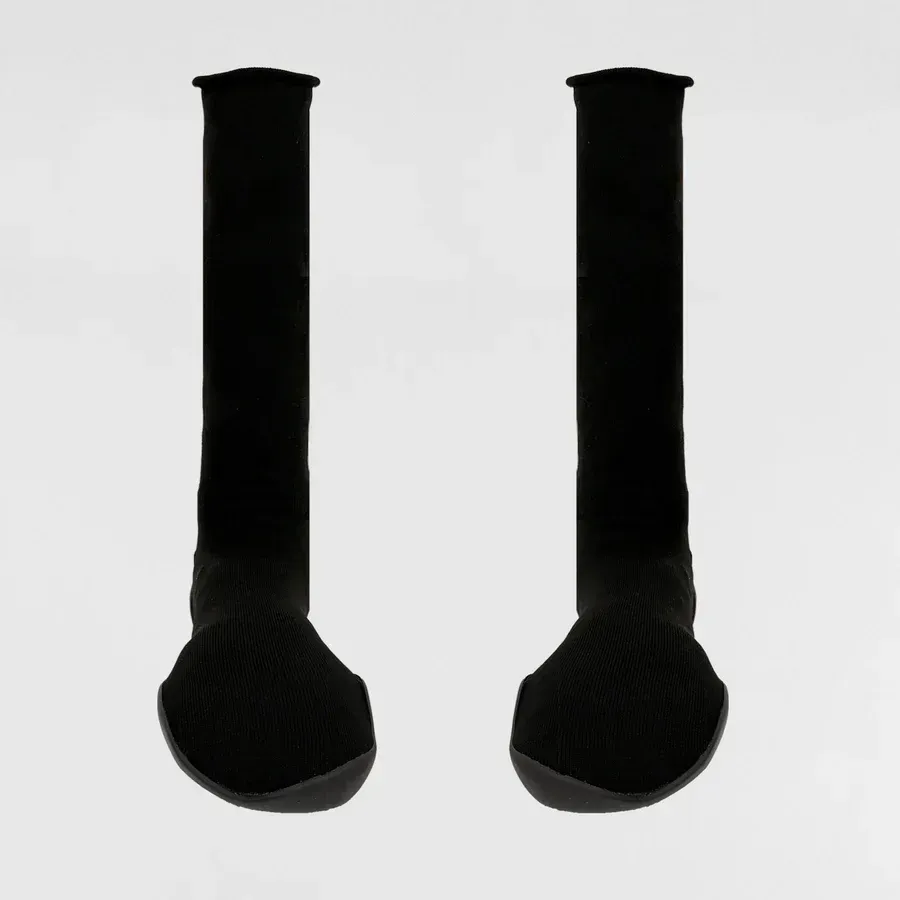 Two black knee-high socks, standing upright against a light gray background.