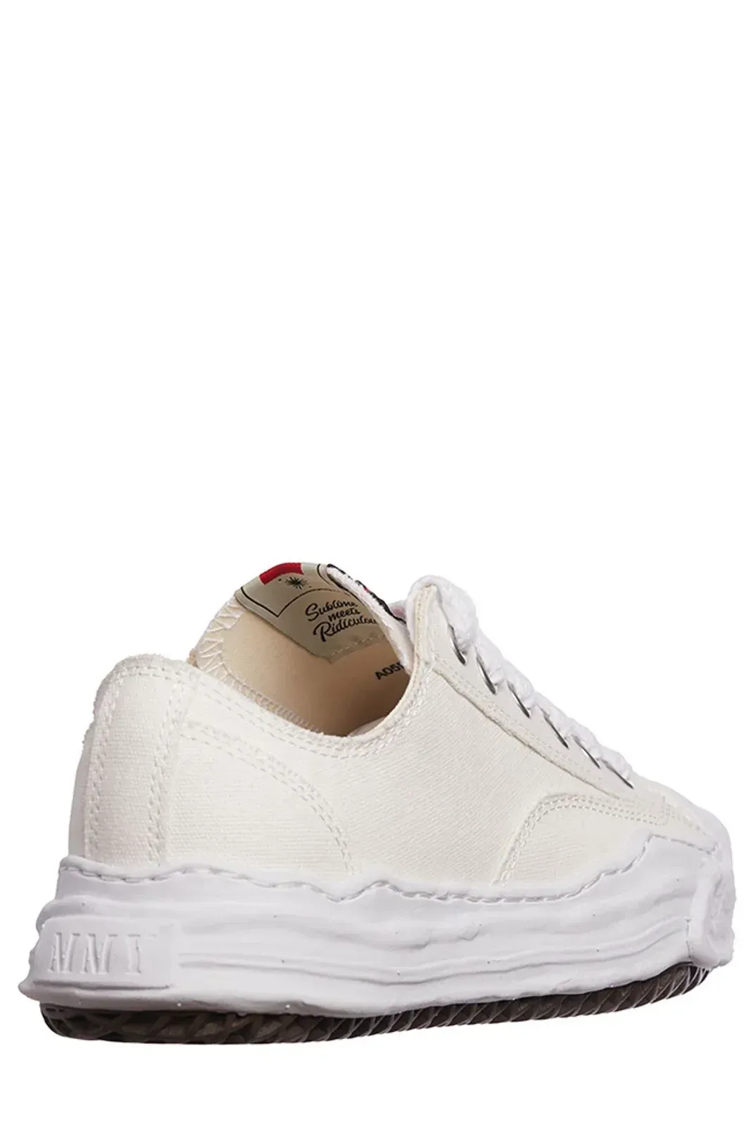 White canvas sneakers with a distressed rubber sole.