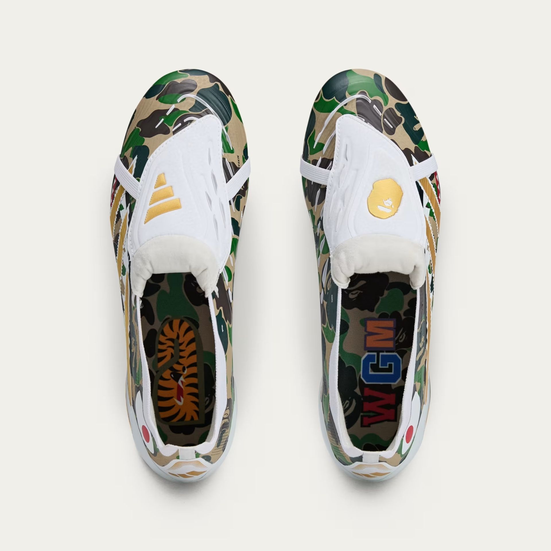 Pair of camo slip-on sneakers with white accents and gold detailing.