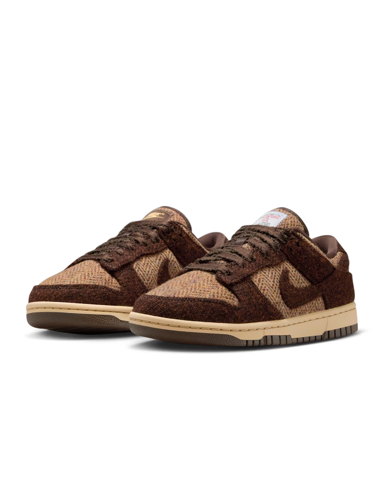 Brown and tan Nike Dunk Low sneakers with textured material.