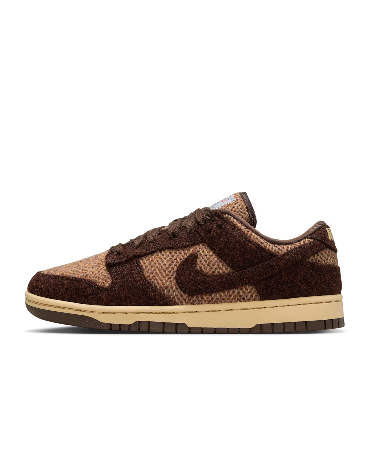 Brown and tan Nike Dunk Low sneakers with textured material.