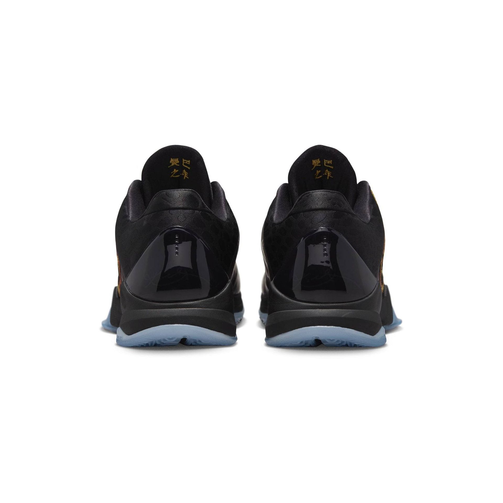 Black athletic shoes, back view, with gold accents and a blue sole.