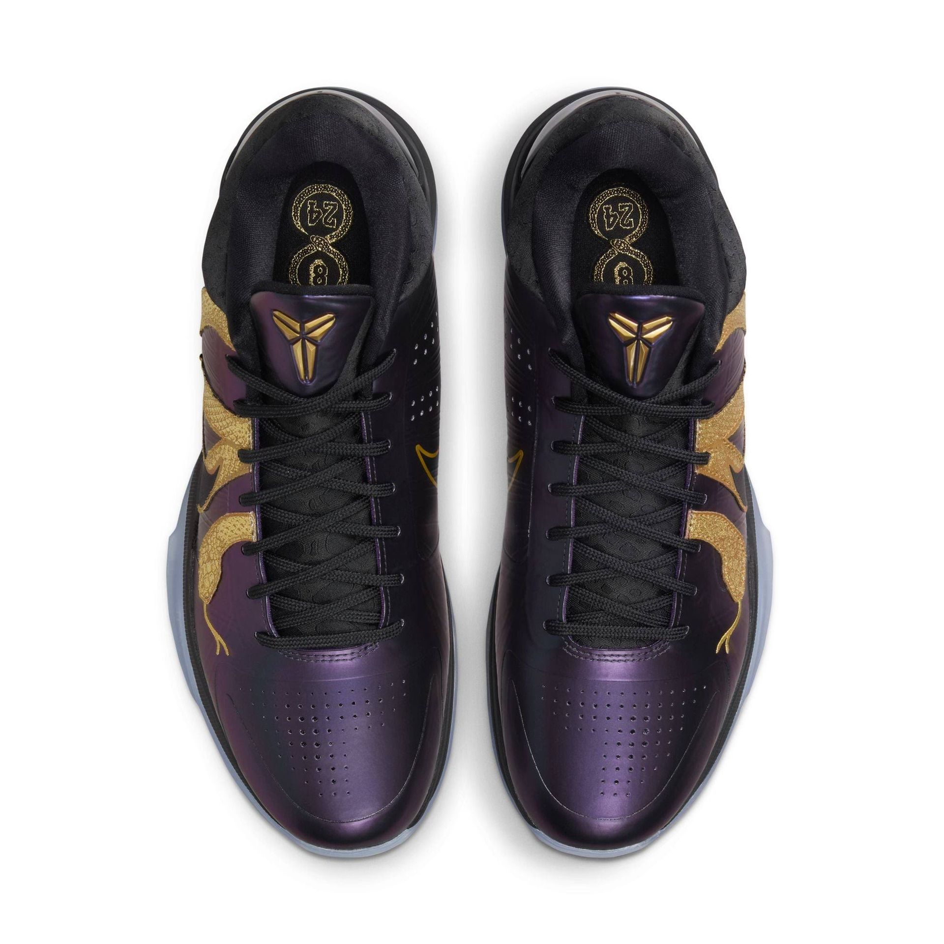 Purple and gold Nike Kobe basketball shoes, top-down view.
