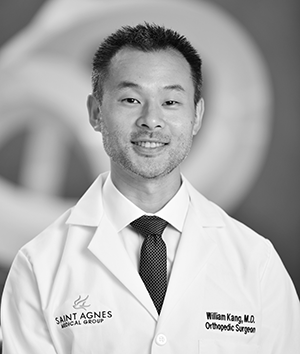 Professional headshot of Dr. William Kang, Orthopedic Surgeon at Saint Agnes Medical Group, wearing a white lab coat and tie.