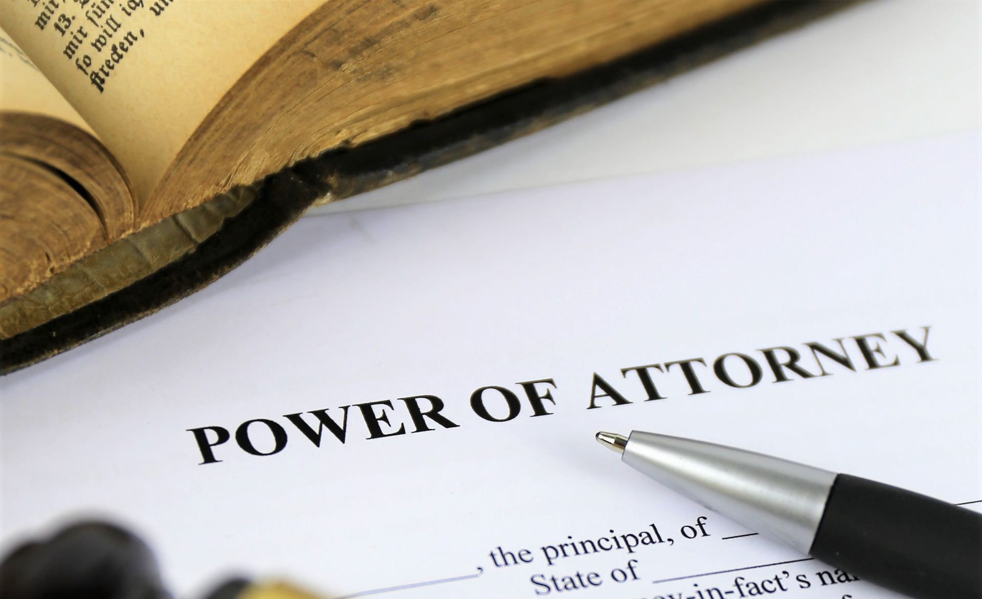 A gavel is sitting on top of a power of attorney form