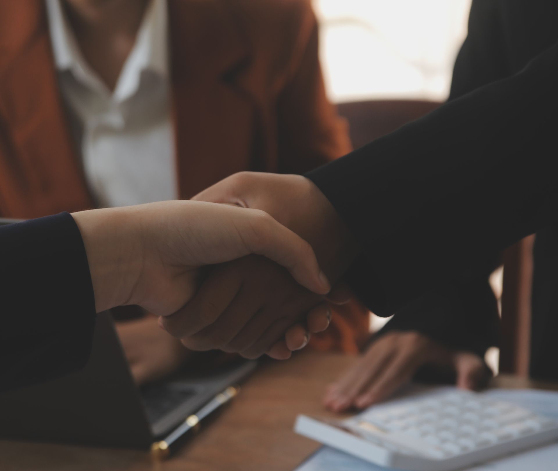 A man is sitting at a desk with a clipboard and a judge 's gavel