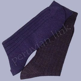 Two alpaca wool socks, one navy ribbed and the other dark gray, laying diagonally on a light blue background.