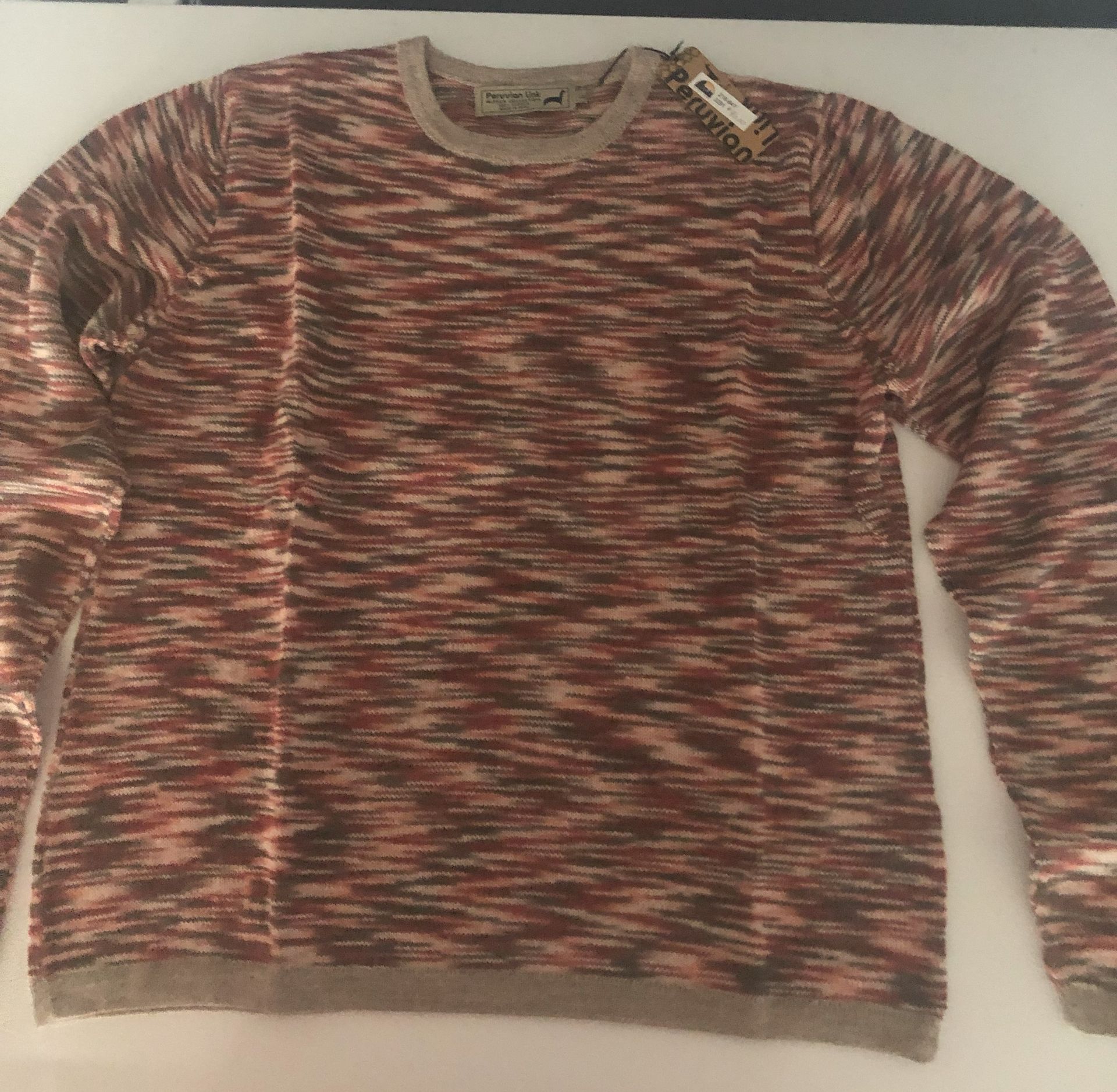 A sweater with a horizontal speckled pattern in brown, tan, and rust tones.