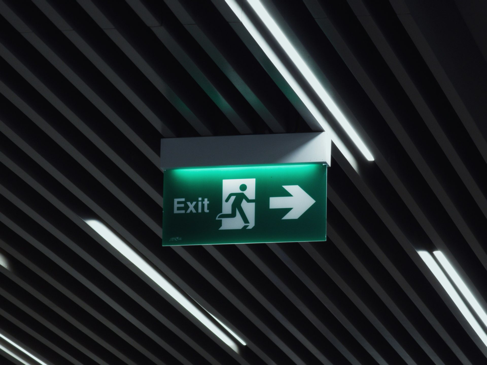 Green exit sign symbolising business exit and succession planning.