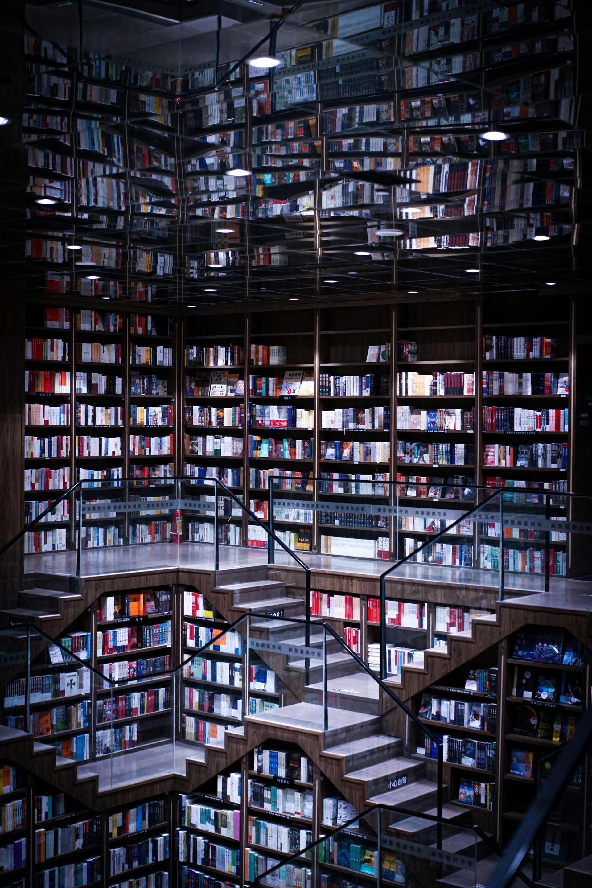 A library of a vast number of books on display, with staircases to different sections of the shelves